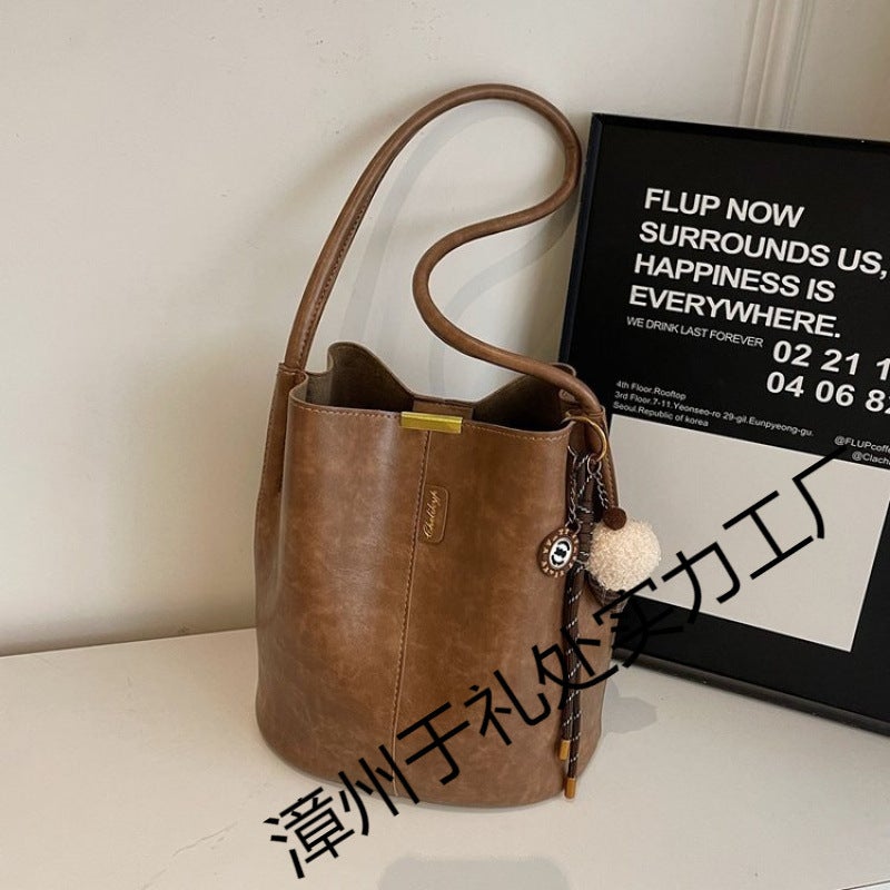 The Retro Bucket Bag Is Decorated With A Playful Fur Ball Pendant. It Can Be Worn On One Shoulder Or Cross-Body, Unlocking A Lazy And Fashionable Feel - Image 4