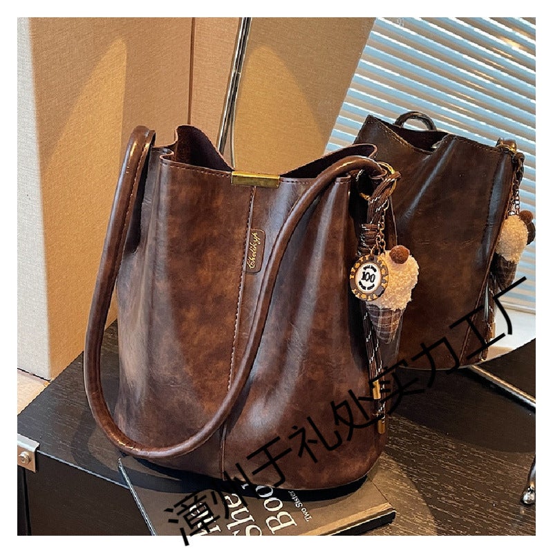 The Retro Bucket Bag Is Decorated With A Playful Fur Ball Pendant. It Can Be Worn On One Shoulder Or Cross-Body, Unlocking A Lazy And Fashionable Feel - Image 2
