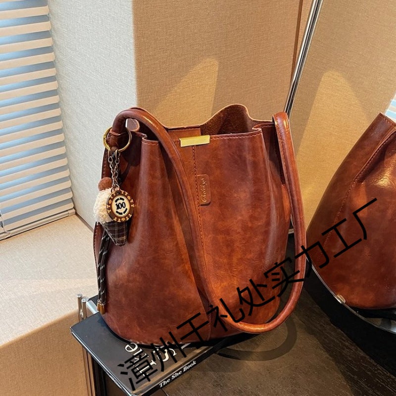 The Retro Bucket Bag Is Decorated With A Playful Fur Ball Pendant. It Can Be Worn On One Shoulder Or Cross-Body, Unlocking A Lazy And Fashionable Feel - Image 3