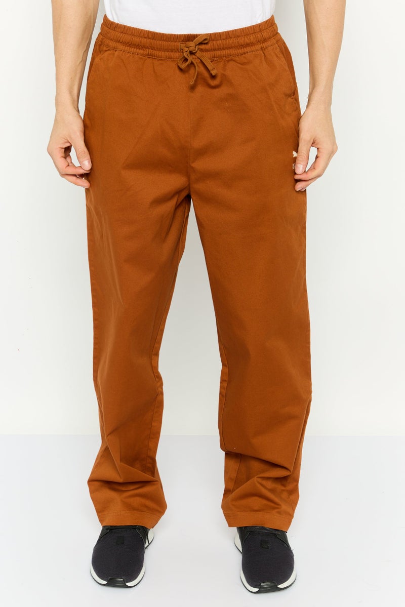 PUMA Men Sportswear Fit Embroidered  Logo Outdoor Sweatpants, Rust Brown  - Image 1