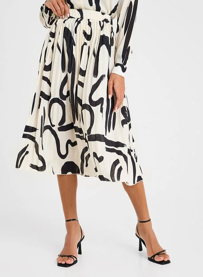 ستايلي تنورة ميدي مطوية بطبعة تجريدية