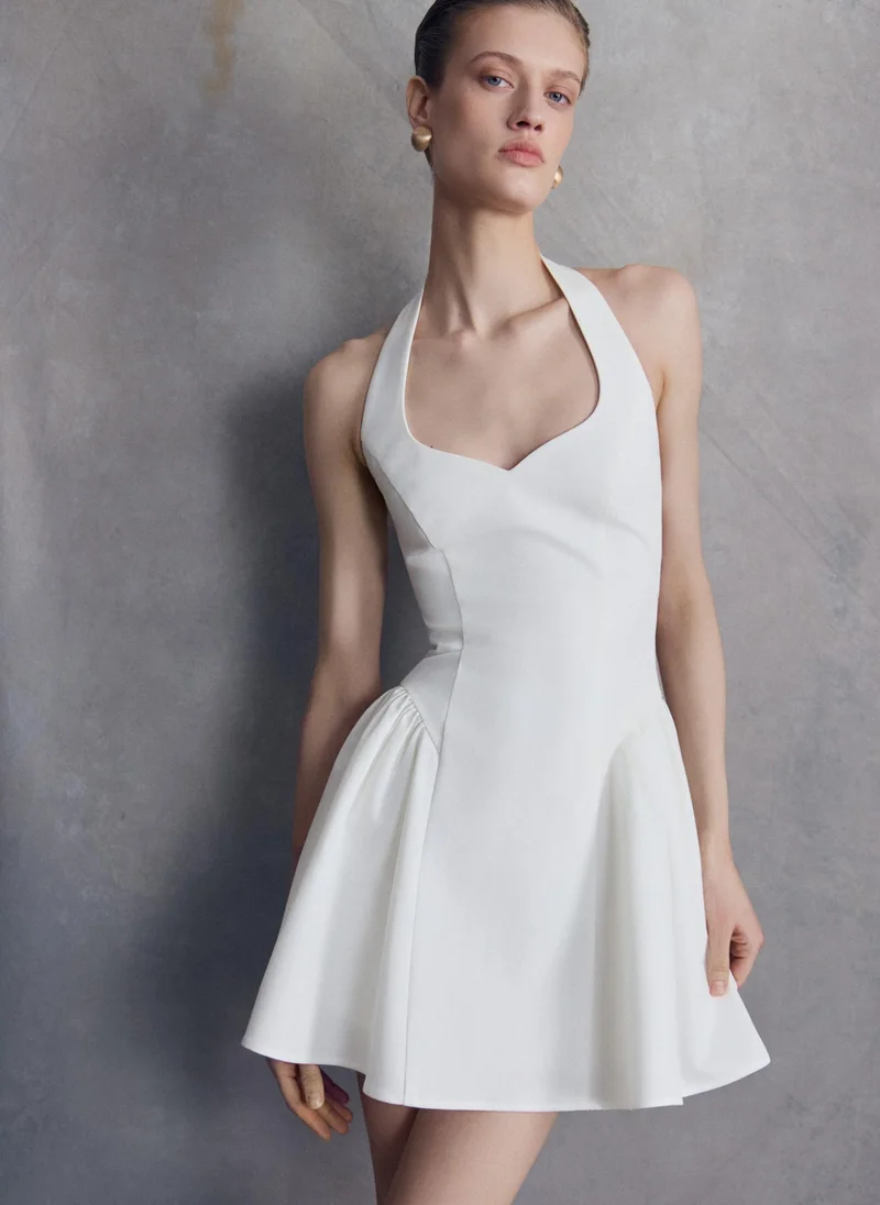 Strapless mini dress with voluminous inserts on the skirt and an open back