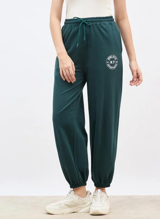 Styli Styli Green Tapered Joggers with Graphic Print