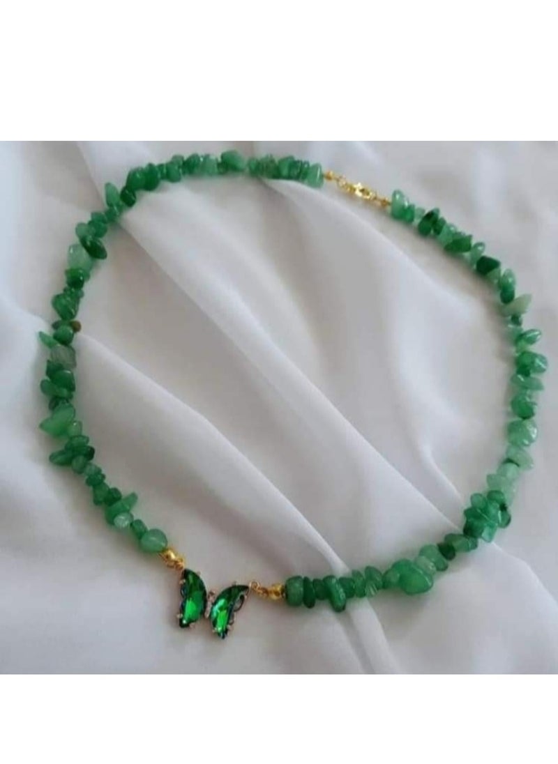 A set of chains made of broken natural stone with a butterfly pendant and bracelets