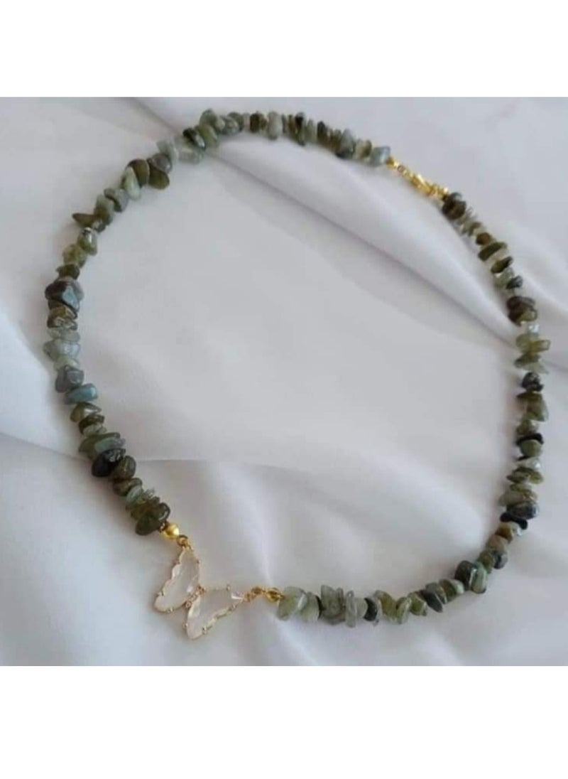 A set of chains made of broken natural stone with a butterfly pendant and bracelets