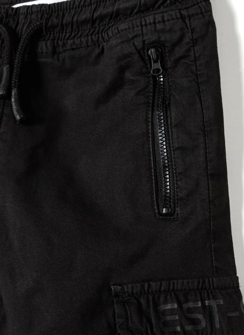 MINOTI Teen Boys Cargo Trousers with Zipped Pockets and a Print