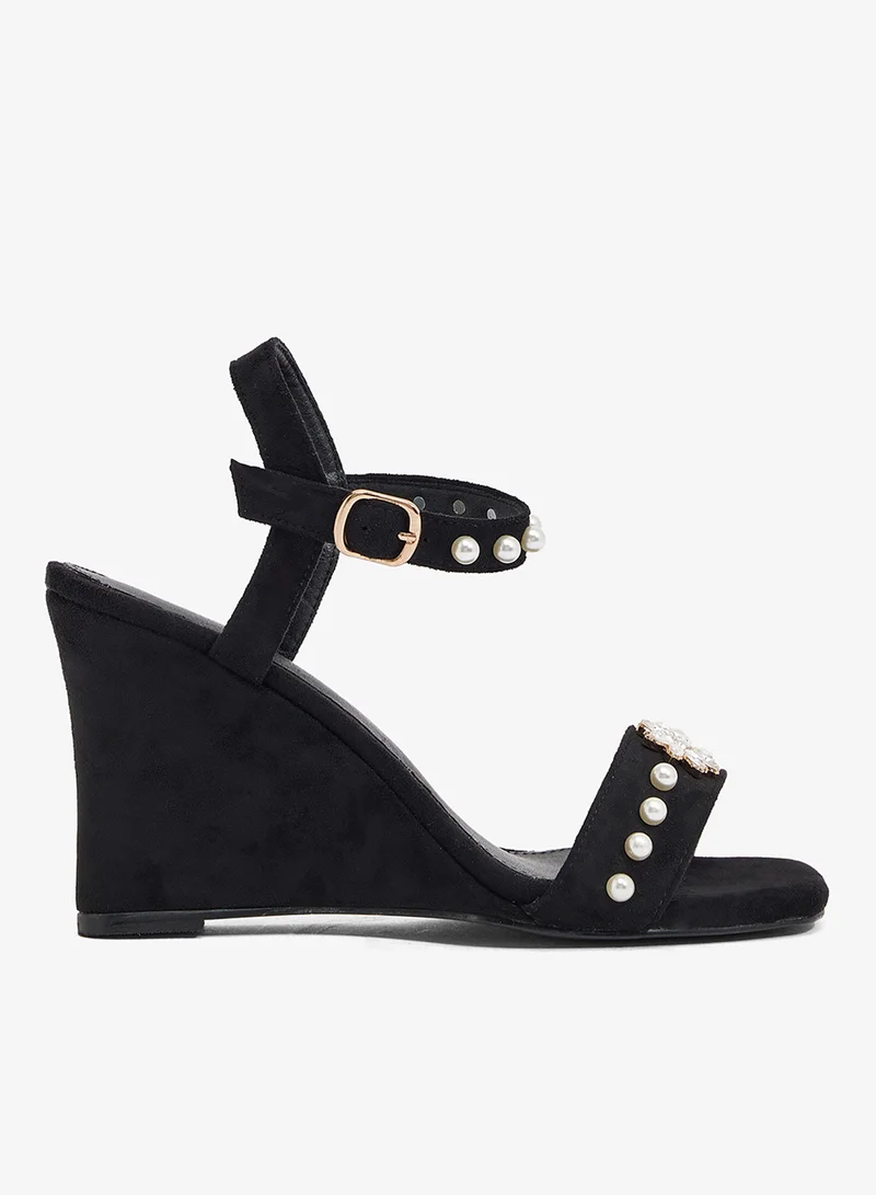 Black wedge sandal with pearl strap and crystal flower embellishment