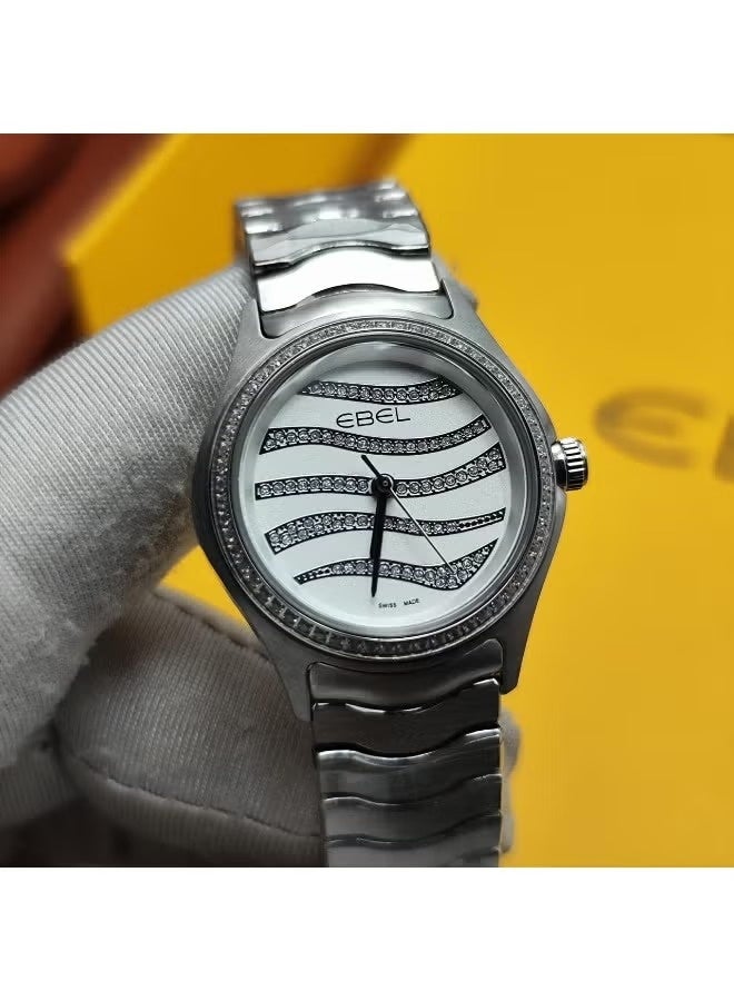 The Ebel women's watch features a classic design with a distinctive wave-shaped strap.