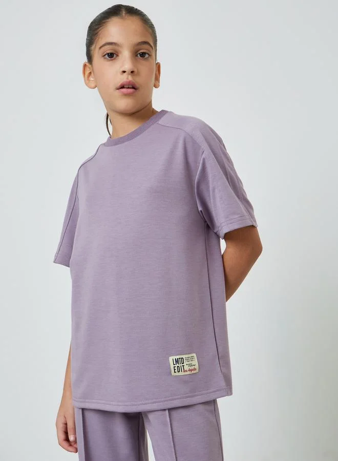 Styli Teens Badge Relaxed Fit T-Shirt And Wide Leg Joggers Set