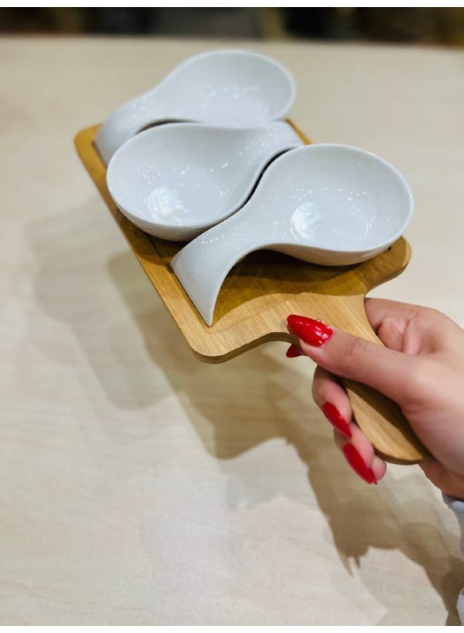 An elegant touch for any table setting 🤍✨ These bowls feature a sleek, fluid design in brilliant white porcelain that exudes cleanliness and sophistication. They are paired with a natural bamboo base that complements the look, adding balance and distinctive beauty.  Designed for serving sauces and delicious accompaniments 👌 Perfect for ketchup, mayonnaise, mustard, melted cheese, dips, small appetizers, and even nuts. - Image 3