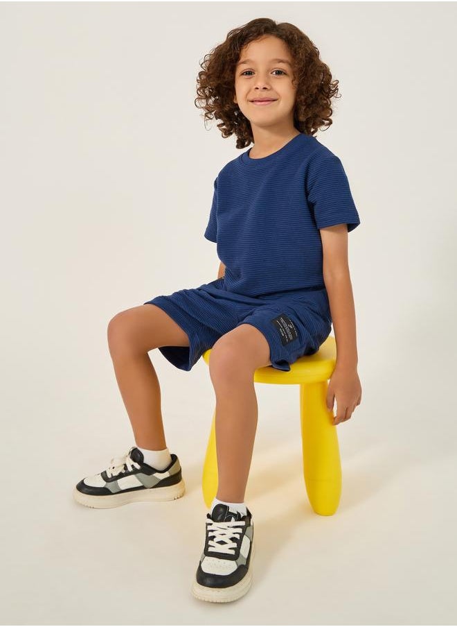 Styli Styli Textured T-Shirt with Badge Detail and Shorts Set  - Image 1