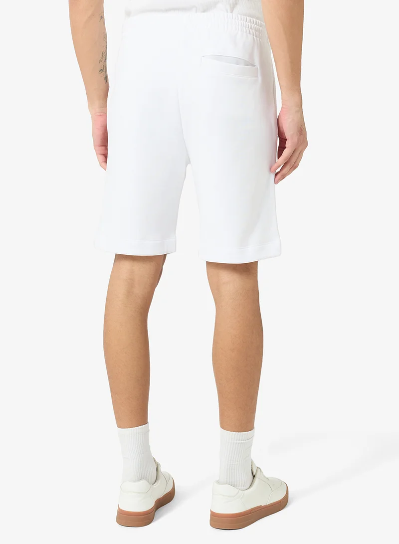 Lacoste white Regular Fit Brushed Fleece Shorts for Men | Best Price UAE