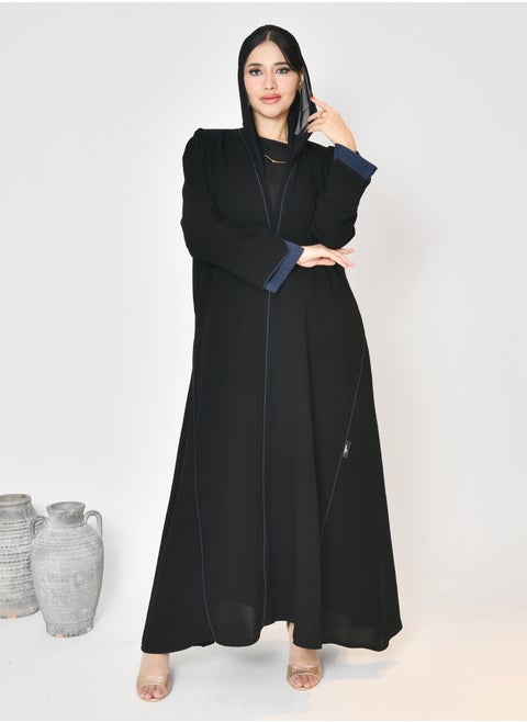 Black wrap abaya with quarter-cloth fabric, puff sleeves, and navy color overlapping on the sleeves and the front and side edges of the abaya in an arrow shape