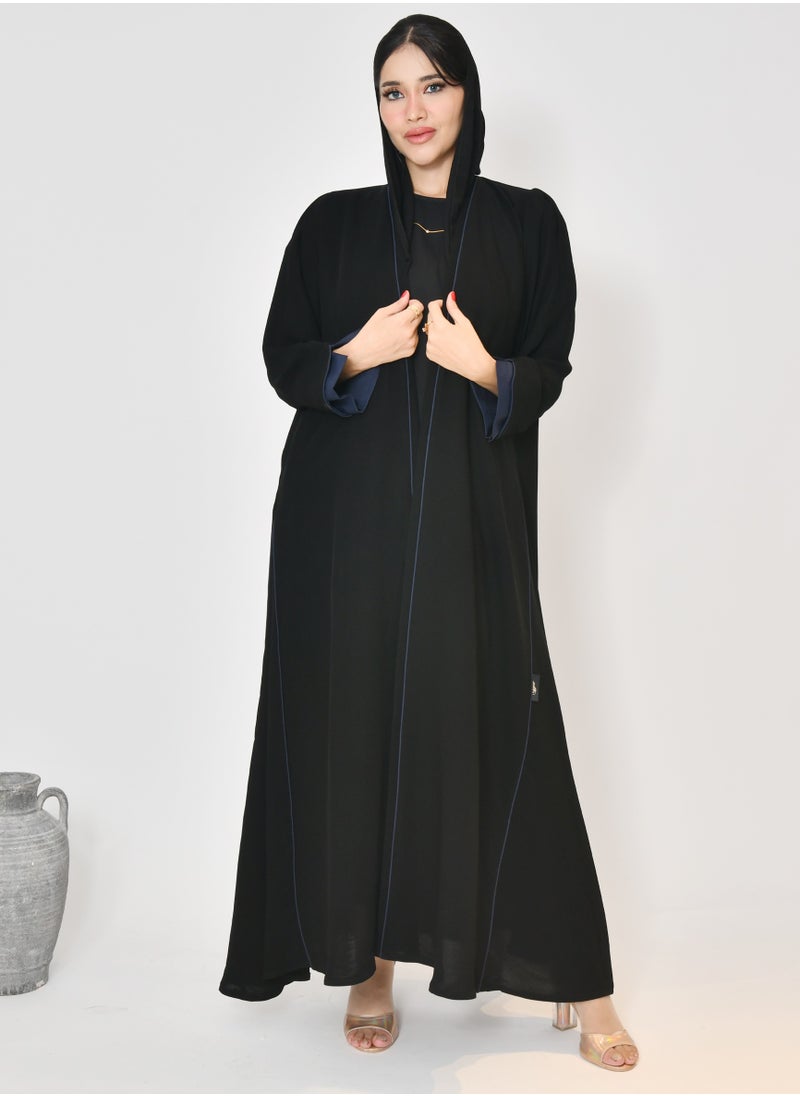 Black wrap abaya with quarter-cloth fabric, puff sleeves, and navy color overlapping on the sleeves and the front and side edges of the abaya in an arrow shape