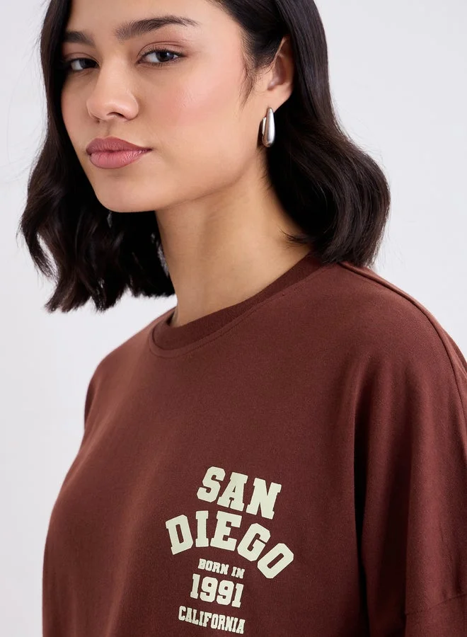 Styli Brown Styli Brown Oversized Back Graphic Print T-Shirt for Women | Best Price UAE