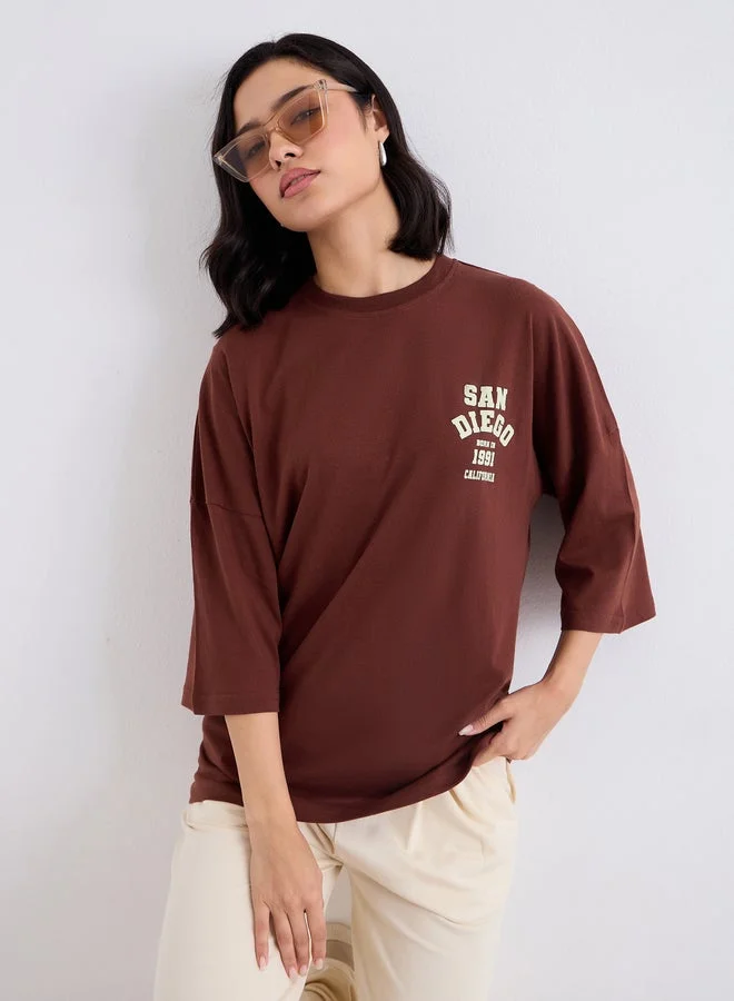 Styli Brown Styli Brown Oversized Back Graphic Print T-Shirt for Women | Best Price UAE
