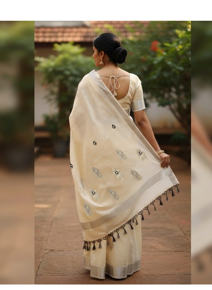 A.M traditional Indian saree, likely a Kerala Kasavu style, featuring a classic off-white or cream body with extensive silver Peacock Feather - Image 1