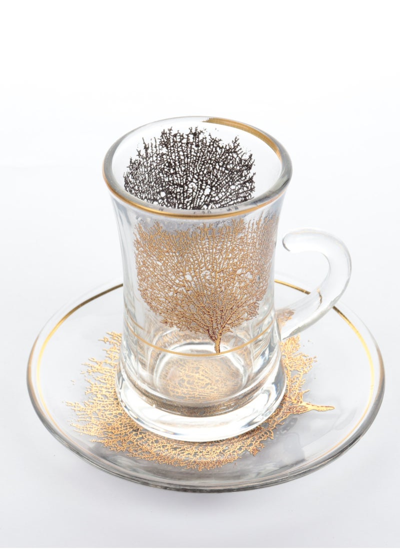 A set of glass and ceramic tea cups and coffee cups with luxurious golden leaf patterns - a luxurious design for a distinctive taste