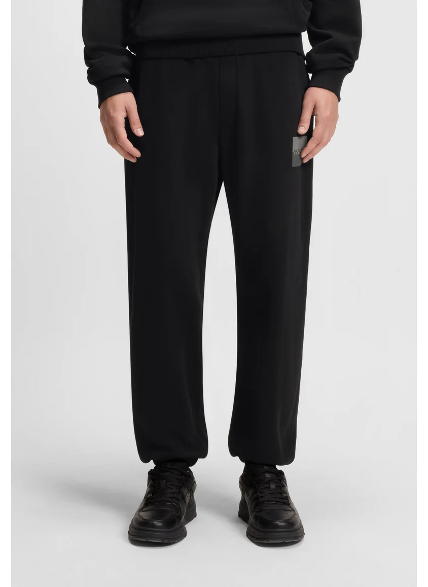 HUGO Cotton-terry tracksuit bottoms with split logo