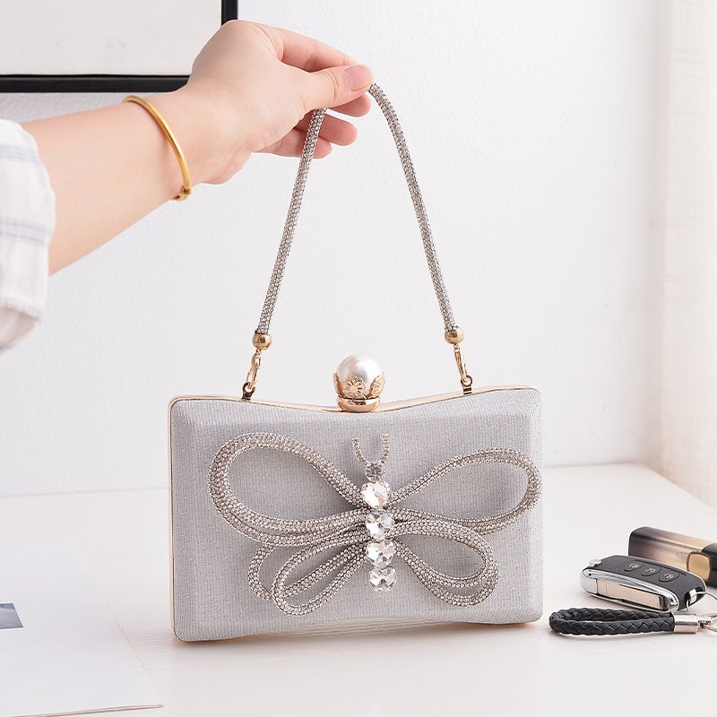 Elegant Black Bow Evening Clutch with Lock Clasp and Crossbody Strap - Image 1