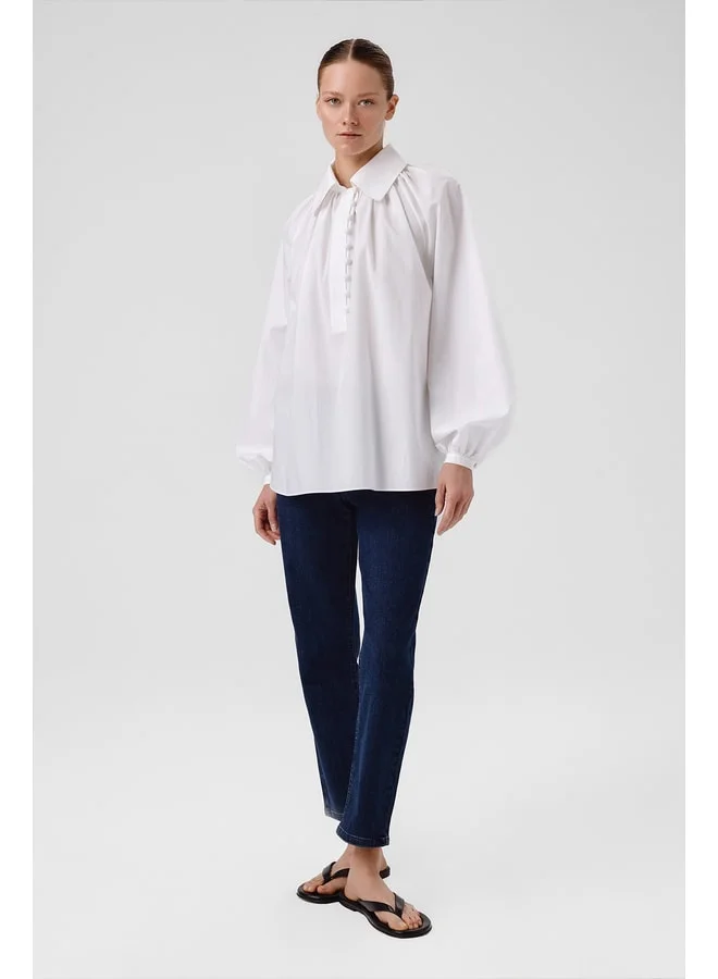 Mısırlı 1951 White balloon‑sleeve blouse with button details.