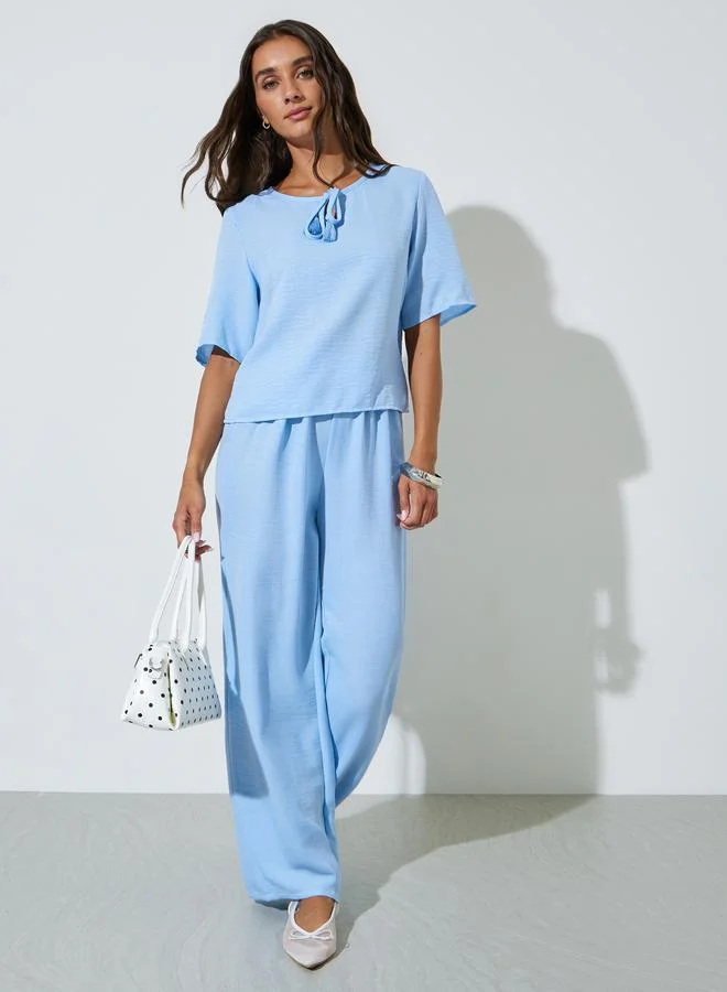 ستايلي Blue Solid Neck Tie Top and Wide Leg Pants Co-Ords
