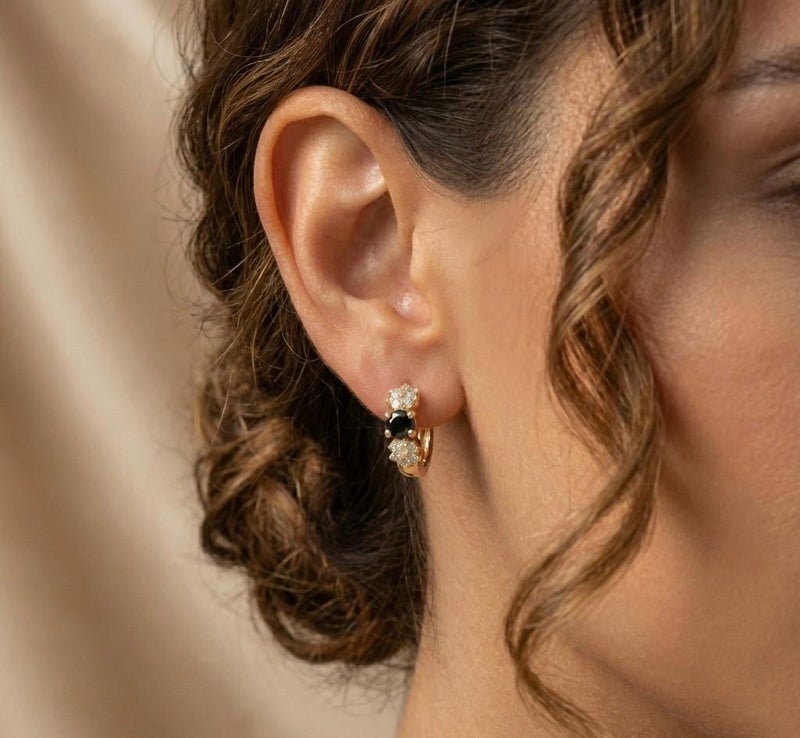 Eye-catching gold earrings, adorned with a round, regal black stone surrounded by sparkling zircon flowers. A perfect blend of luxury and elegance for a captivating everyday look. - Image 3