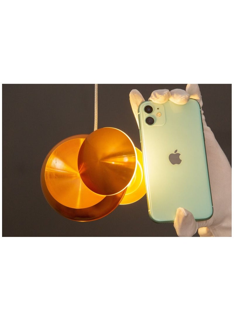 A golden chandelier hanging from the ceiling with a yocandel pendant