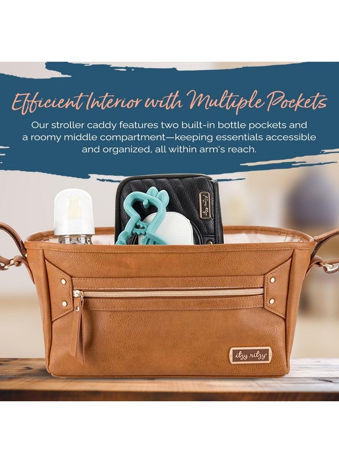Itzy Ritzy Adjustable Stroller Caddy/Organizer - Stroller Organizer Bag Featuring Front Zippered Pocket, 2 Built-in Interior Pockets & Adjustable Straps to Fit Nearly Any Stroller (Cognac) - Image 1