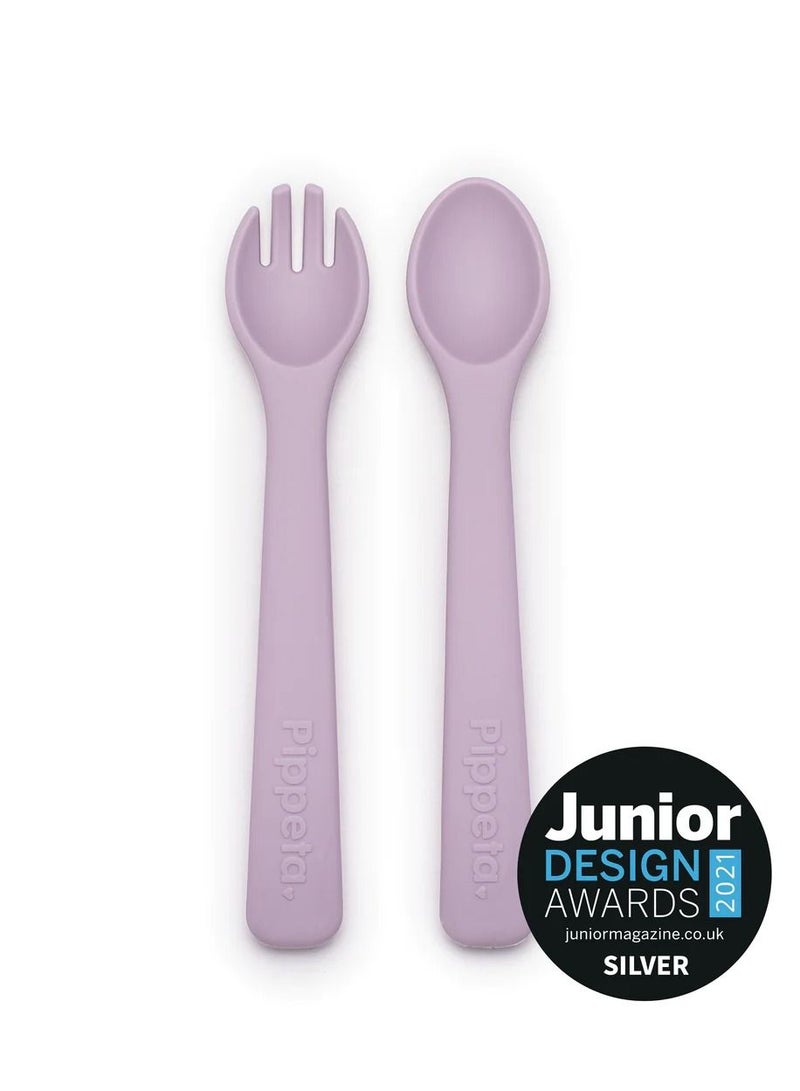 Pippeta The Pippeta Silicone Baby Spoon & Fork Set is designed to make early feeding safe, simple, and comfortable for little ones. Made from soft, BPA-free silicone, it is gentle on gums and ideal for babies starting their self-feeding journey. The small, baby-friendly size fits perfectly into tiny mouths, while the easy-grip handles help encourage independent eating skills. Durable, flexible, and easy to clean, it is dishwasher and microwave safe for everyday convenience. A practical feeding essential that combines safety, comfort, and simplicity in one thoughtfully designed set. - Image 1