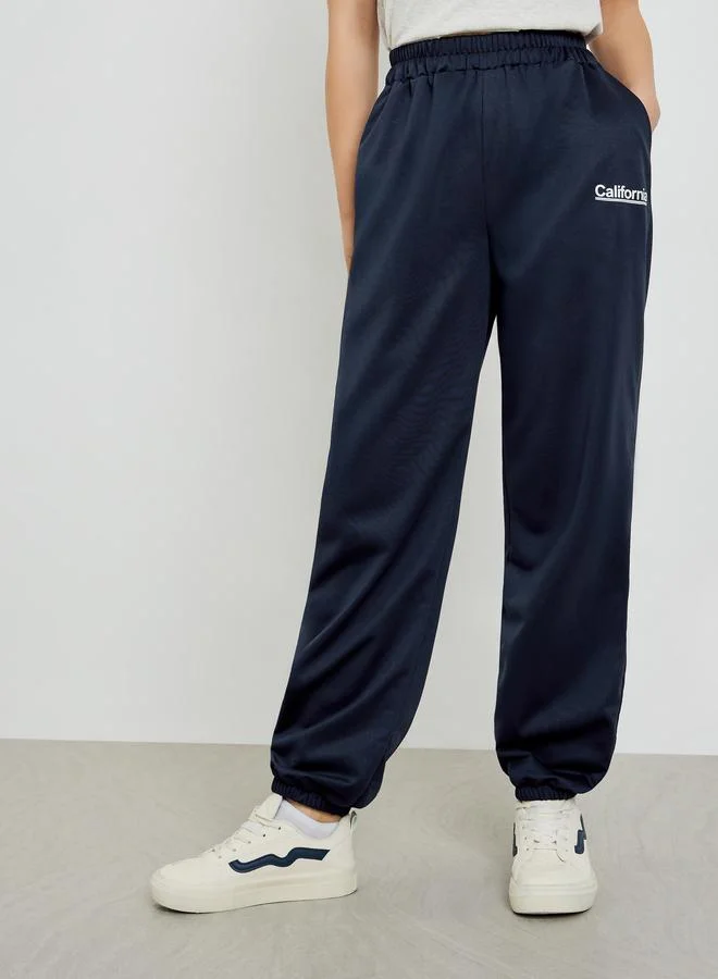 Styli Navy Blue Slogan Printed Wide Leg Joggers