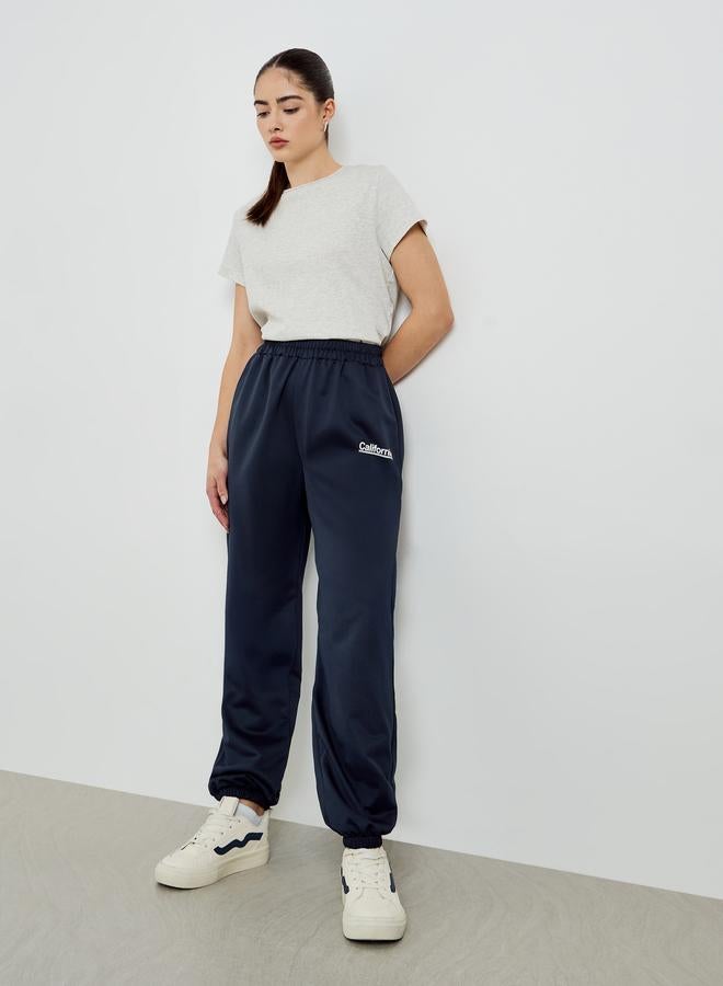 Styli Navy Blue Slogan Printed Wide Leg Joggers - Image 1