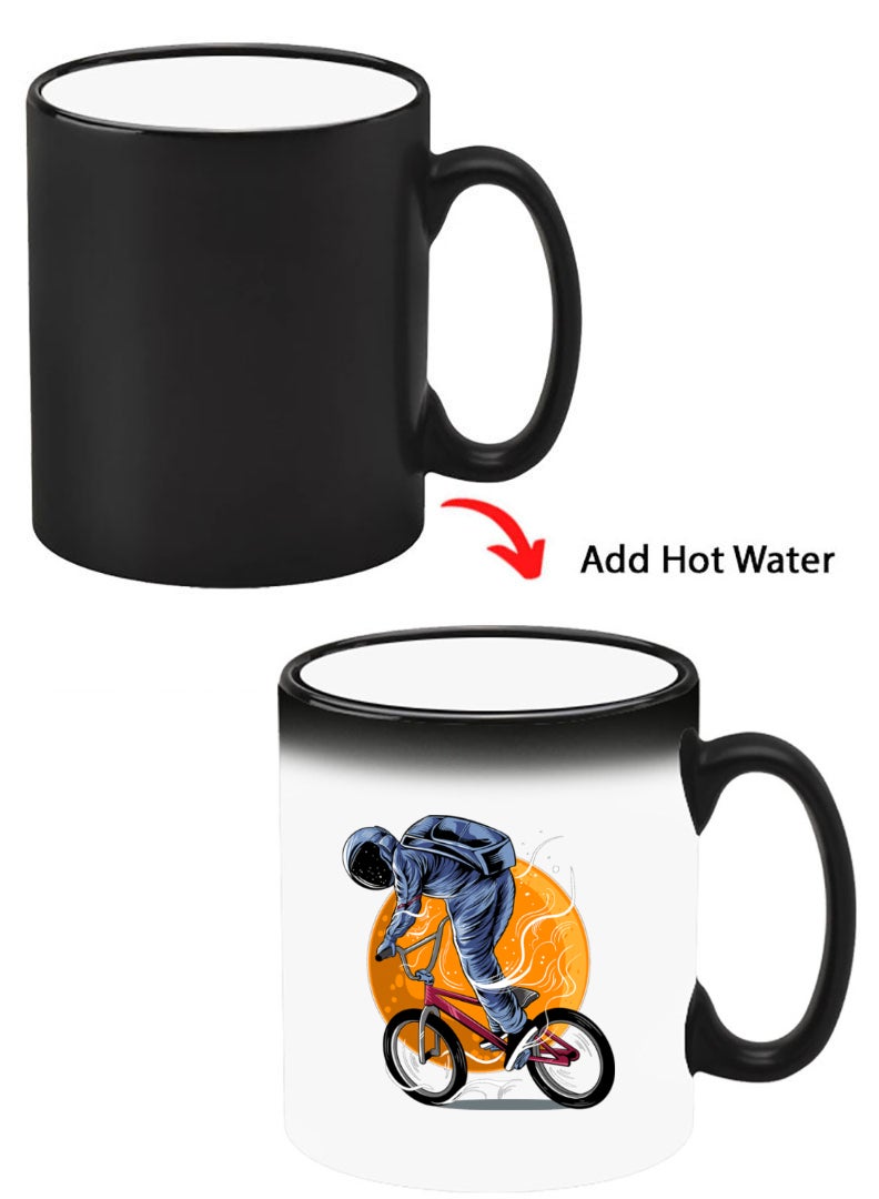 Theodor Color Changing Heat Sensitive Ceramic Mug, Image Revealed When HOT Liquid is Added! Astronaut riding Bike - Image 1