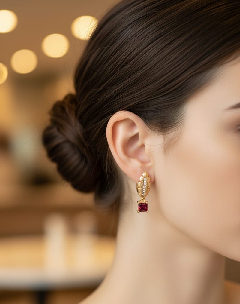 A delicate gold-plated hoop featuring an elegant feather design and sparkling zircon stones, from which hangs a shiny red square zircon piece. - Image 4