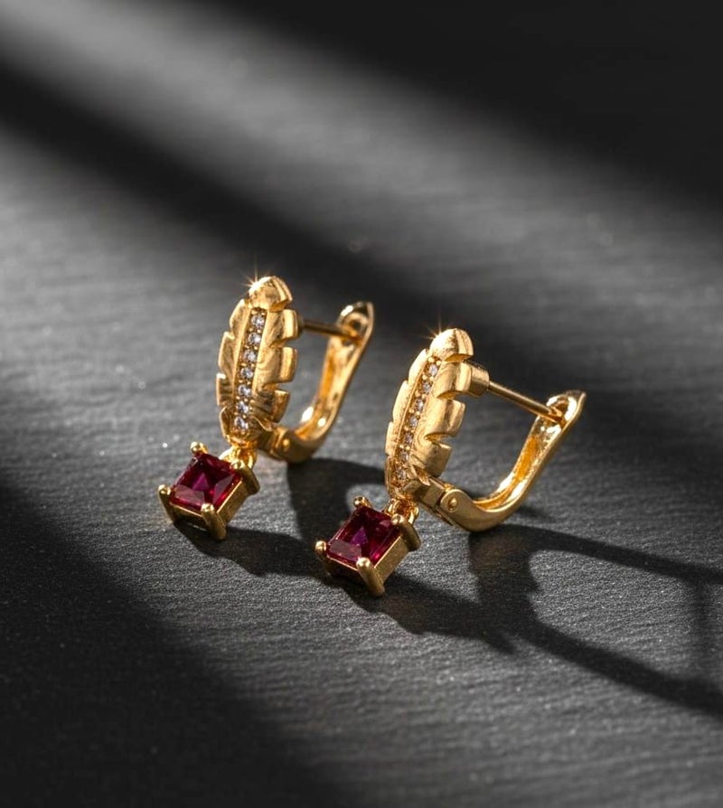 A delicate gold-plated hoop featuring an elegant feather design and sparkling zircon stones, from which hangs a shiny red square zircon piece. - Image 3