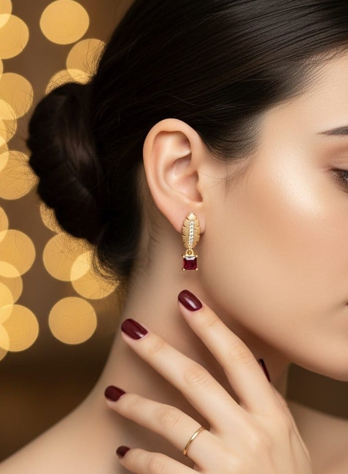 A delicate gold-plated hoop featuring an elegant feather design and sparkling zircon stones, from which hangs a shiny red square zircon piece. - Image 2