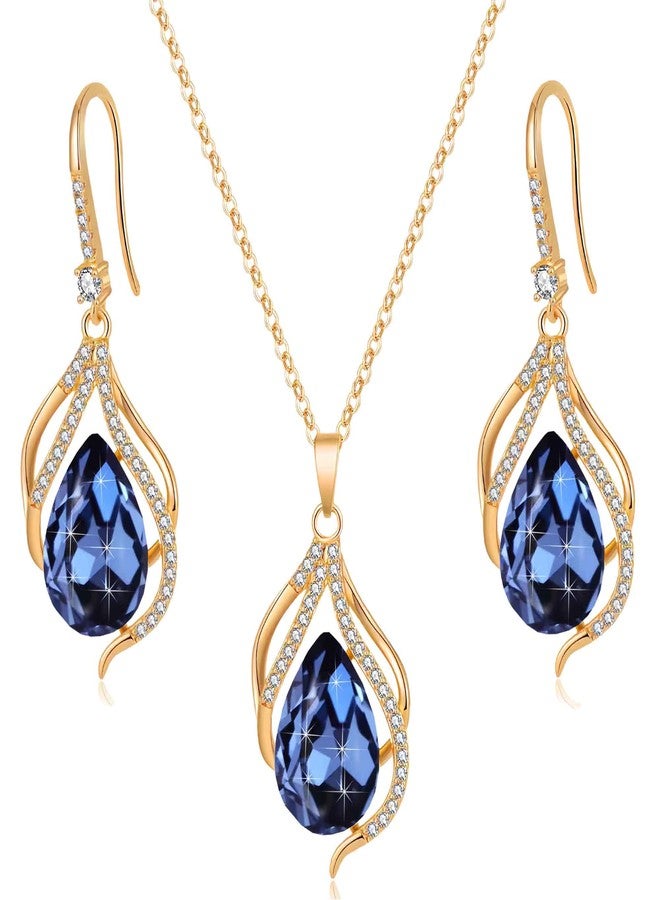 إيفيفك طقم مجوهرات نسائي من إيفيفيك، يتألف من قلادة وأقراط بتصميم دمعة مجوفة ملتوية مرصعة بكريستال نمساوي، مطلية بالذهب عيار 14 قيراط، بتصميم هالة متدلية، مضاد للحساسية (أزرق داكن)، معدن وكريستال وذهبي وردي. - Image 1