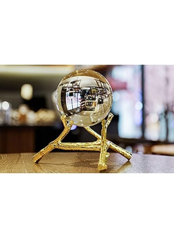 Clear glass crystal ball with a gold metal stand featuring a tree branch design - elegant, nature-inspired office and home decor - Image 1