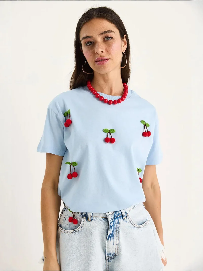 Bianco Lucci Baby Blue LUCCI Patterned Crew Neck T-Shirt with Accessories Detail for Women | Best Price UAE