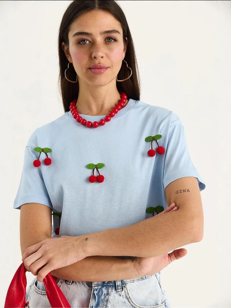 Bianco Lucci Baby Blue LUCCI Patterned Crew Neck T-Shirt with Accessories Detail for Women | Best Price UAE