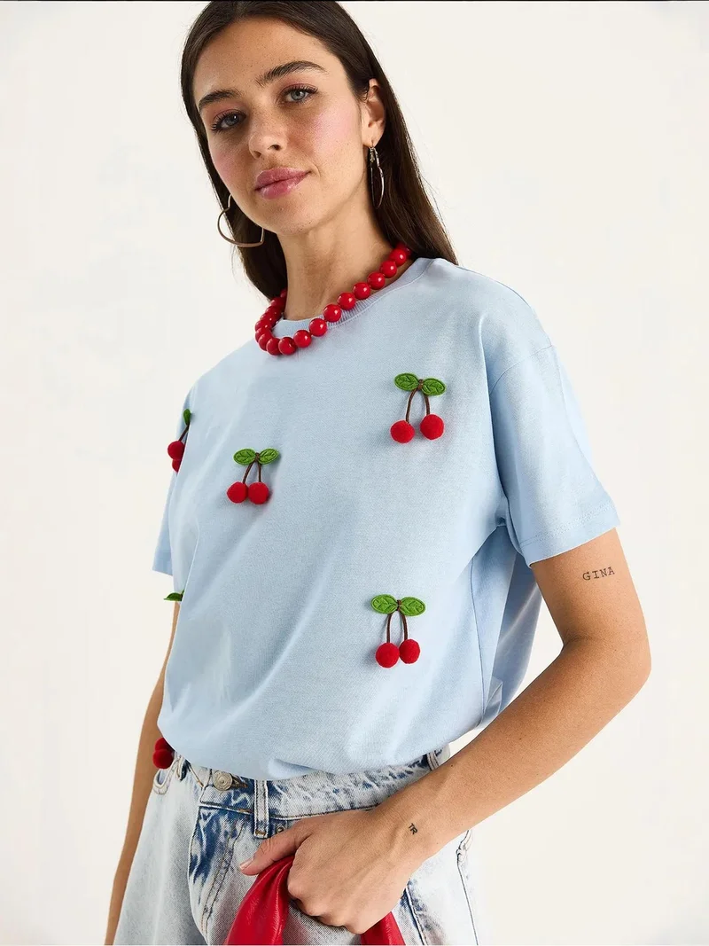 Bianco Lucci Baby Blue LUCCI Patterned Crew Neck T-Shirt with Accessories Detail for Women | Best Price UAE