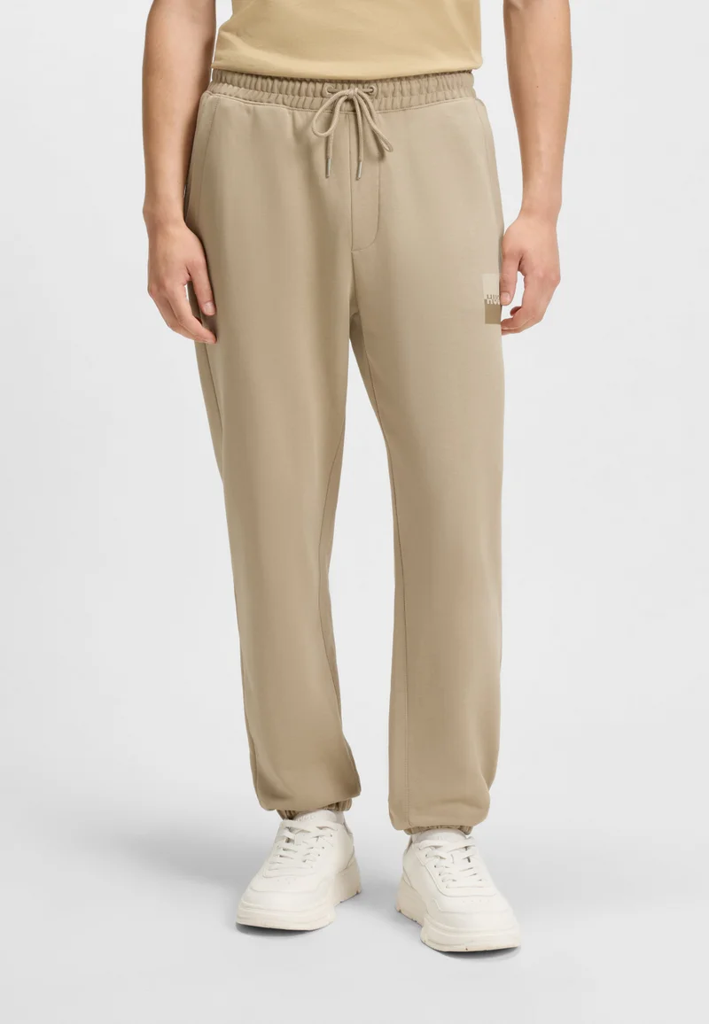 هوجو Cotton-terry tracksuit bottoms with split logo