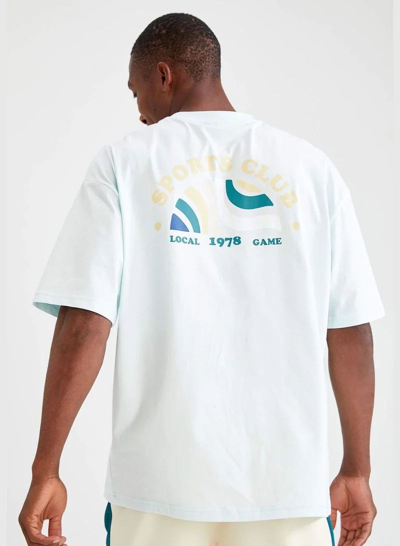 ديفاكتو Oversize Fit Short Sleeve Back Printed Boat Neck T Shirt