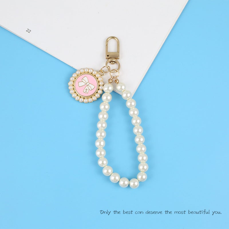 New Pearl Car Keychain Pendant Creative Bow Pearl Round Brand Accessories سماعة أذن مجموعة ديكور حقيبة النساء - Image 1