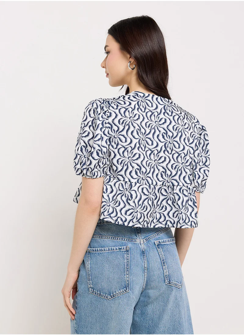 جينجر Puff Sleeve Printed Tie Up Peplum Blouse