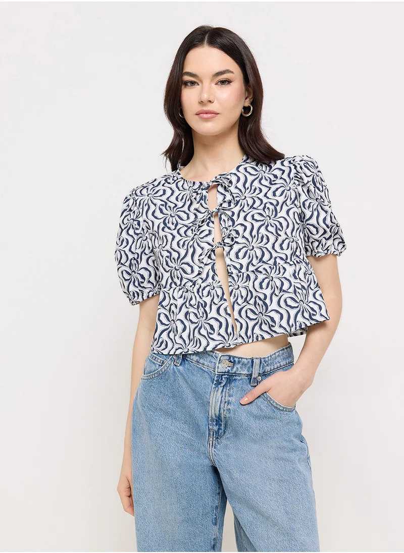 جينجر Puff Sleeve Printed Tie Up Peplum Blouse