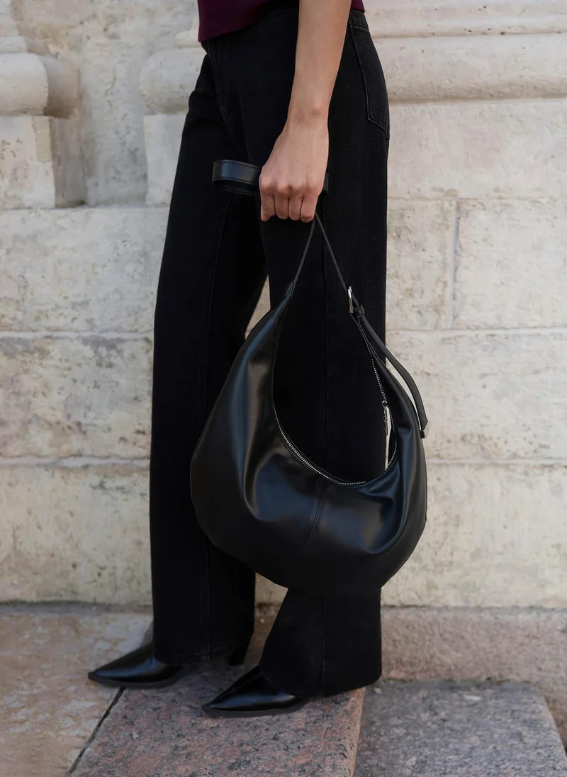 Semi-circular bag with long shoulder strap