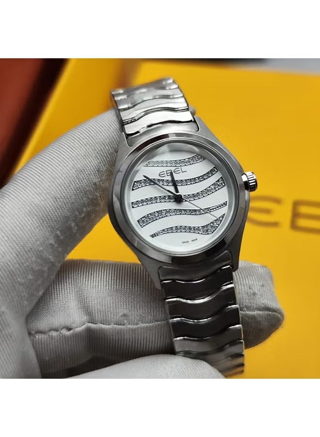 The Ebel women's watch features a classic design with a distinctive wave-shaped strap.