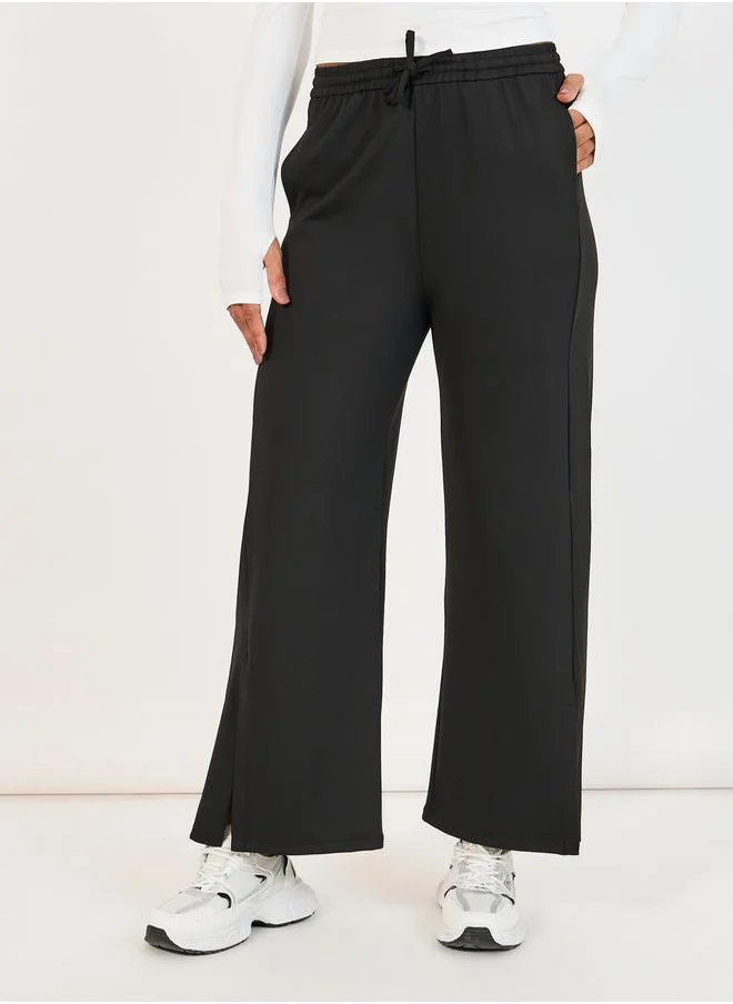 Styli Elastic Waist Slit Pocket Detail Straight Pant with Drawstring Closure