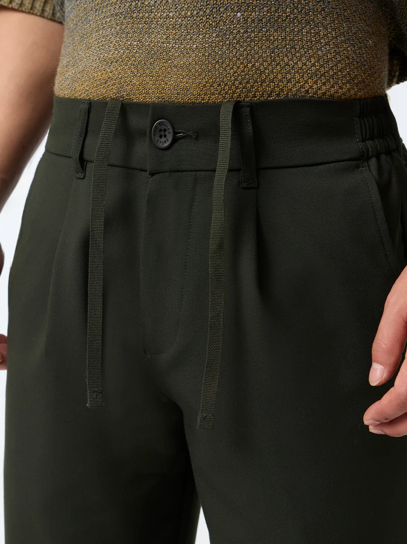 The Souled Store  The Souled Store Straight Pleated Pants: Carbon Men and Boys Dark Olive Green Solid Polyester Viscose Elastane Blend Straight Fit 4-Way Stretch Wrinkle-Free Trousers  | Best Price UAE